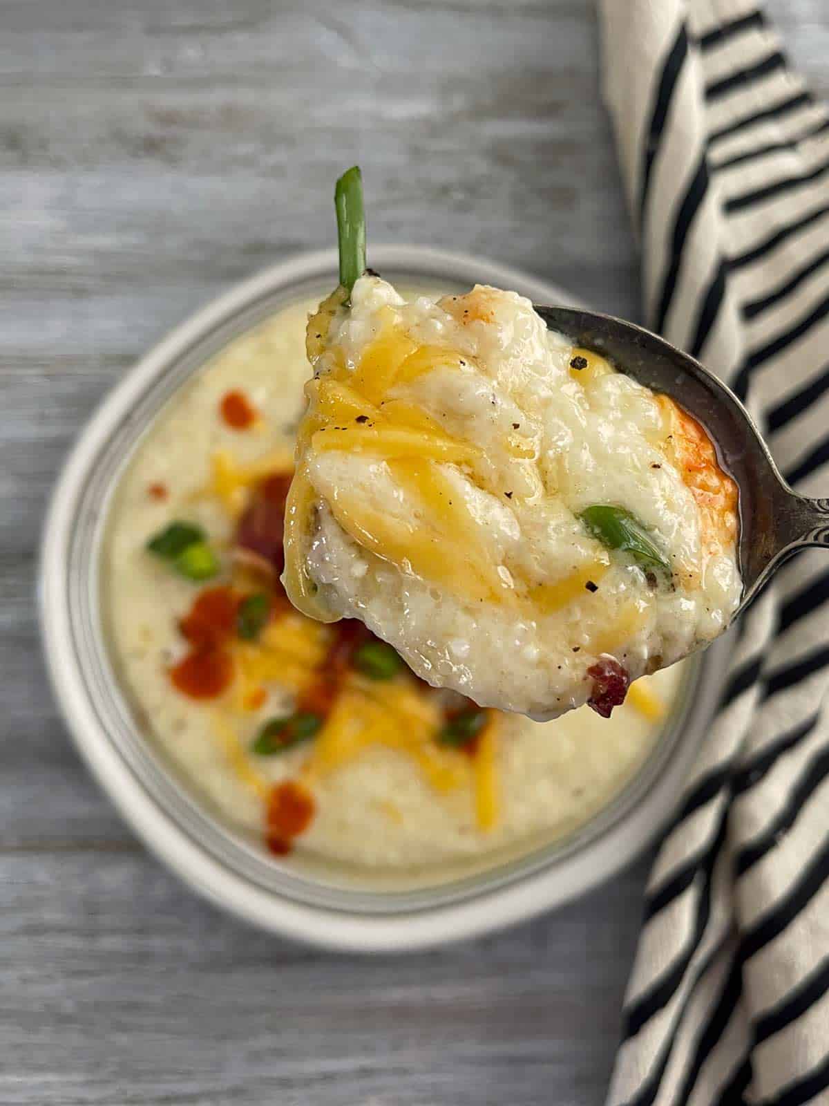 Plate of grits with a spoonful lifted up.