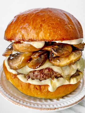 Mushroom burger with Swiss cheese melting out.