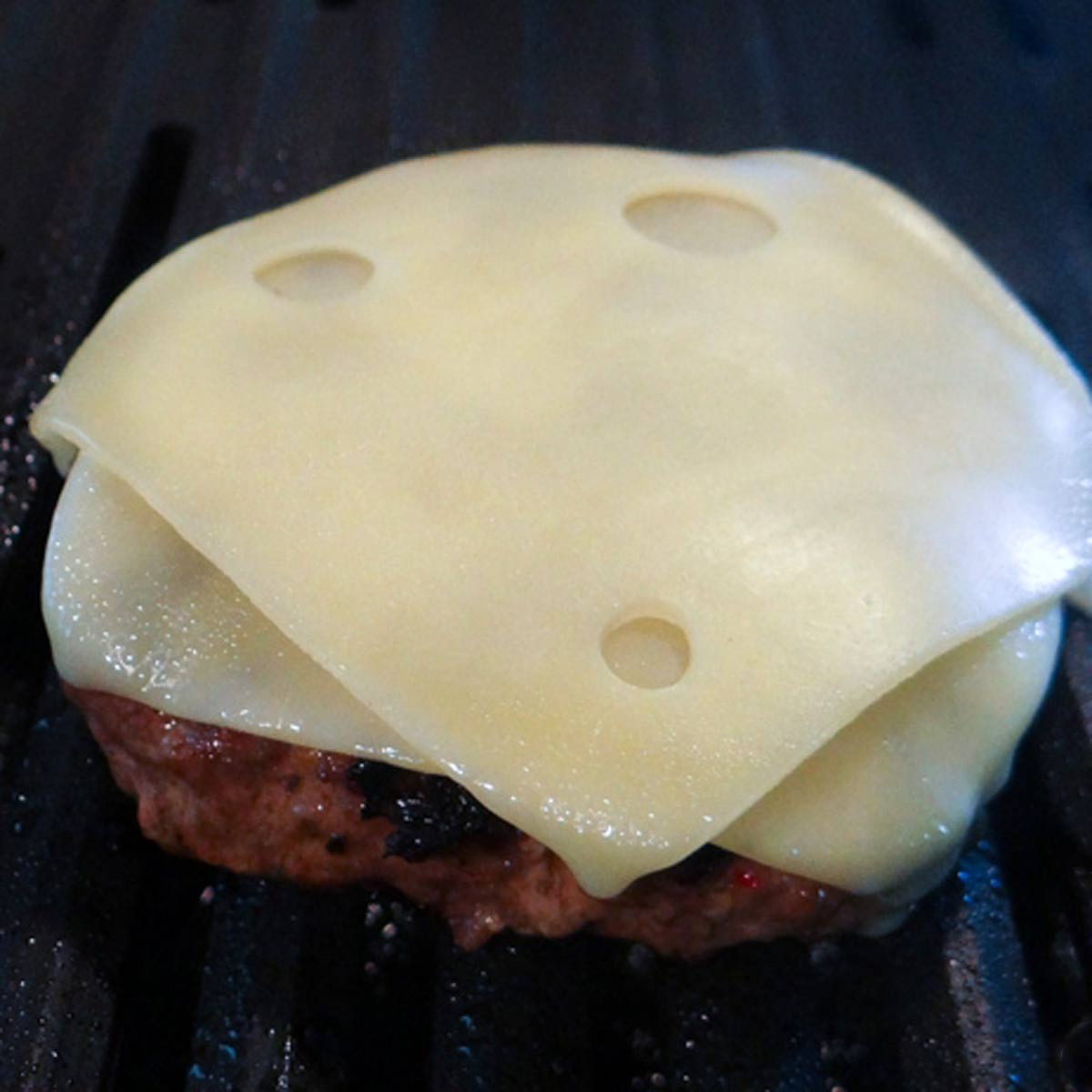 Two slices of Swiis on each burger patty.