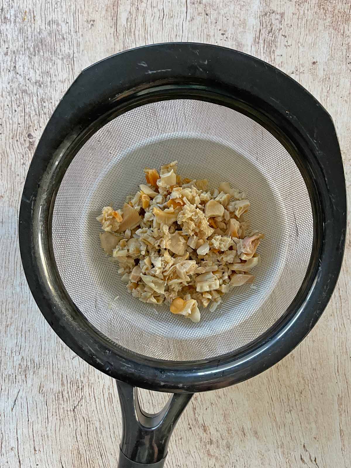 Strainer with draining clams.
