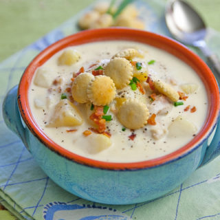 Soup bowl with creamy clam chowder and oyster crackers.