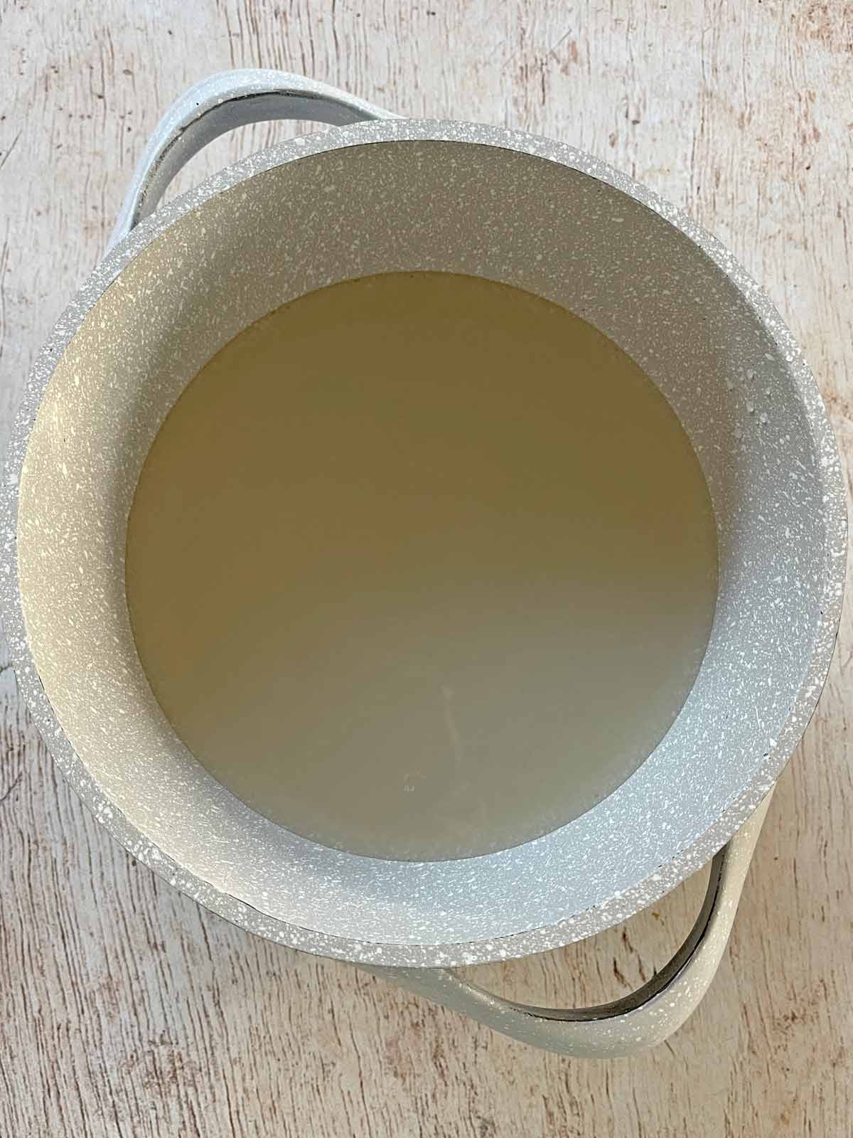 Clam juice in saucepan.