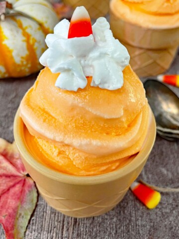 Candy corn ice cream in a cone-shaped bowl.