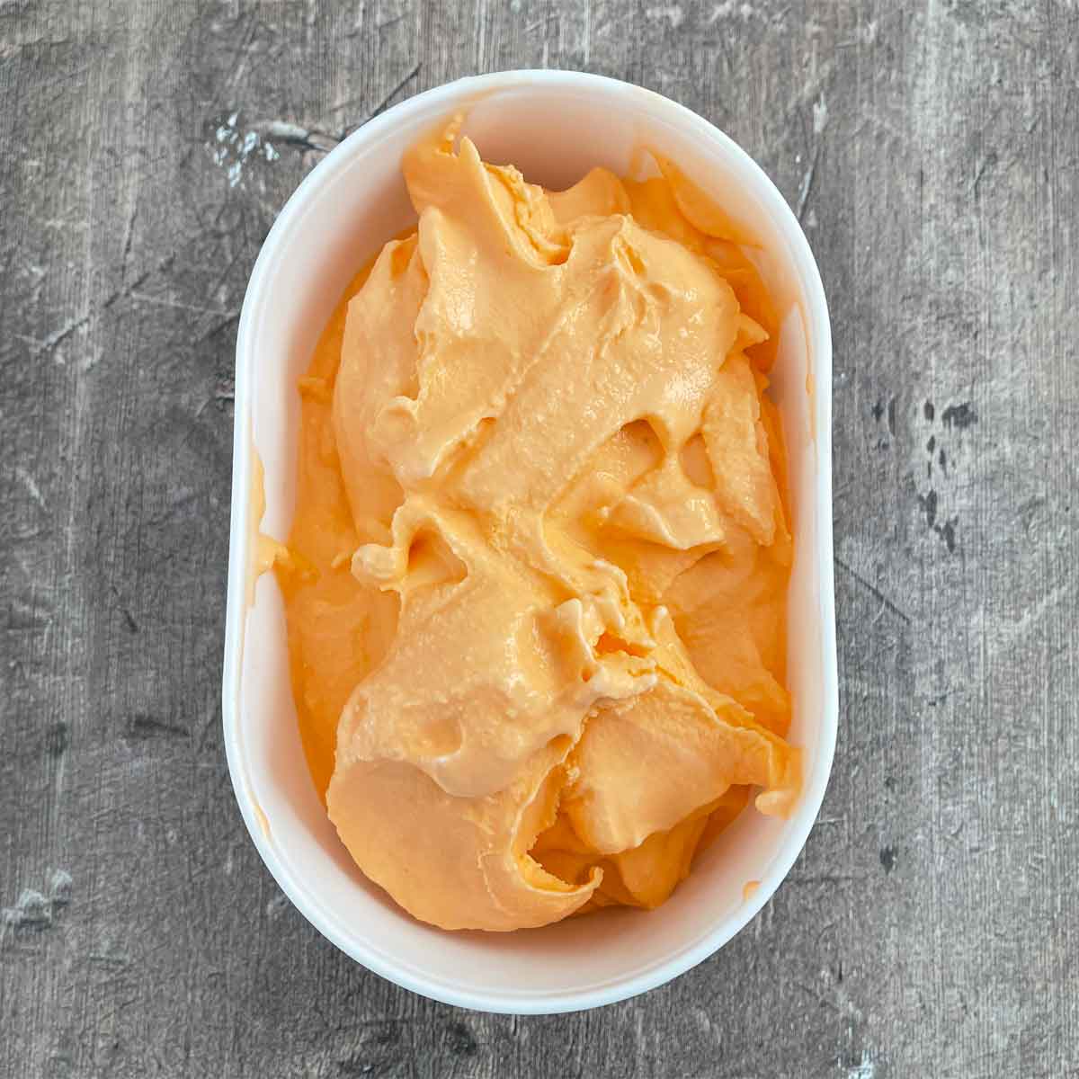 soft serve ice cream in plastic container ready for freezer.