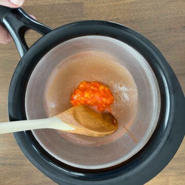 clump of unmelted candy corn in sieve .