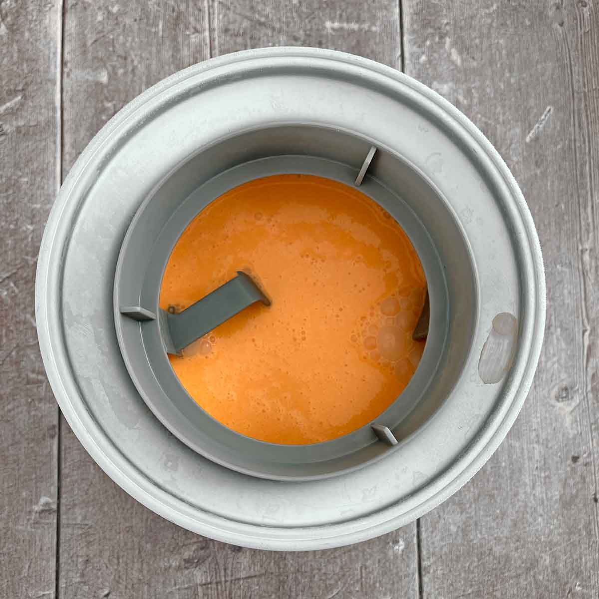 Ice cream machine with ice cream base poured in.