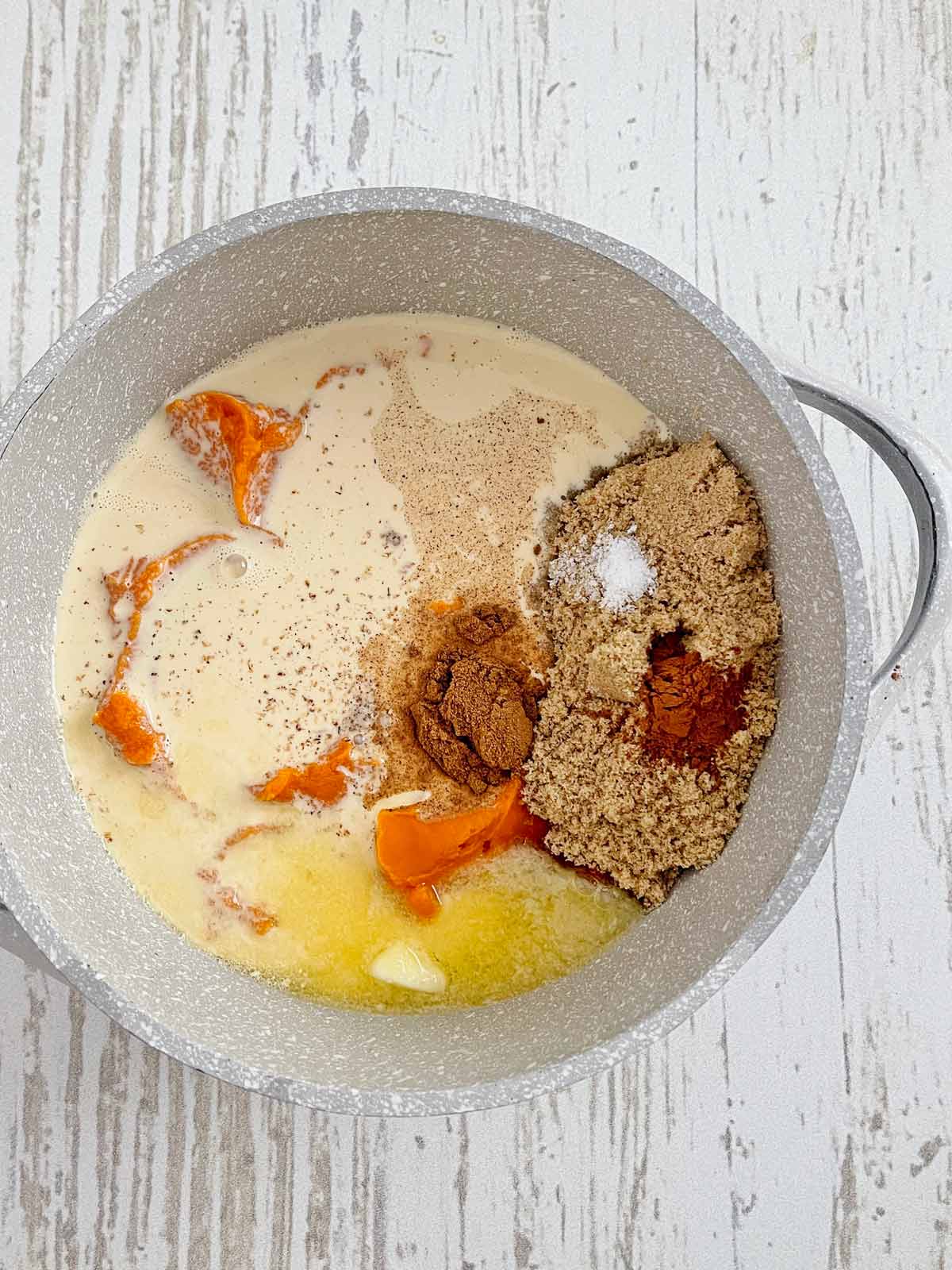 Brown sugar, spices, and evaporated milk are added to the puree in a medium saucepan.