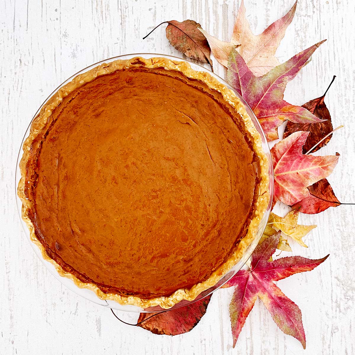 Baked sweet potato pie with Fall leaves.