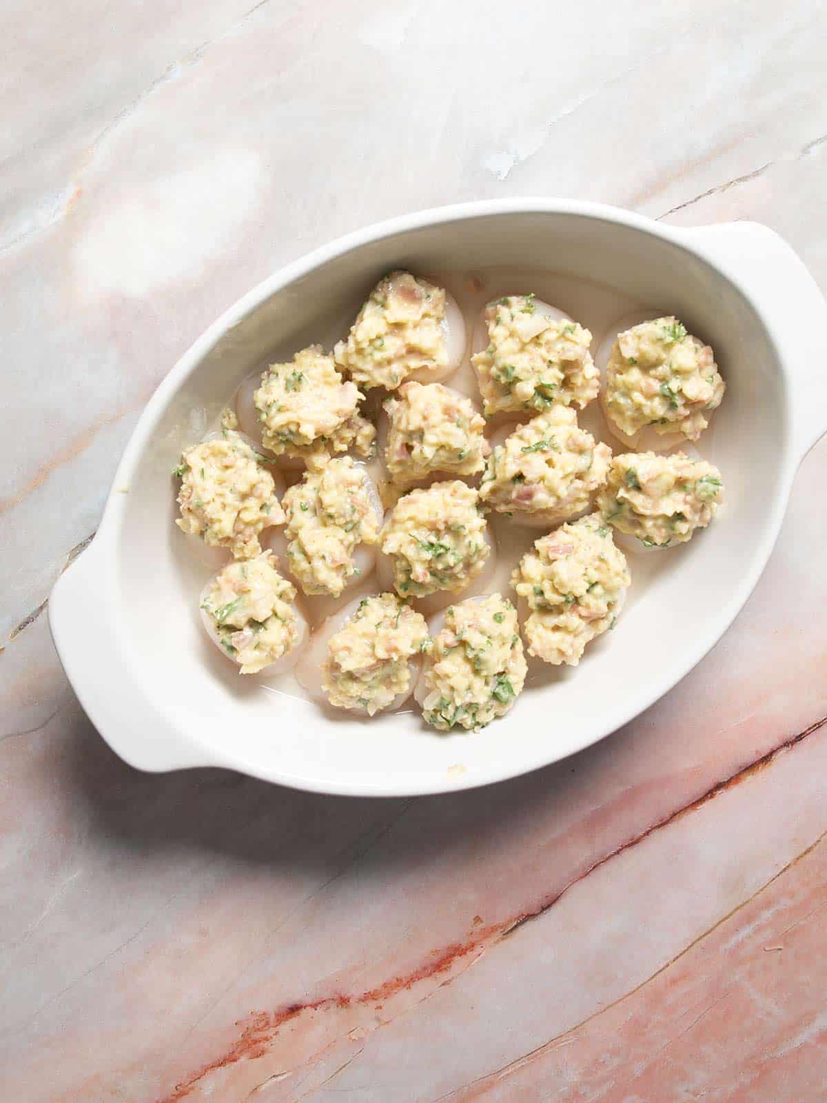 Scallops with topping on each one.