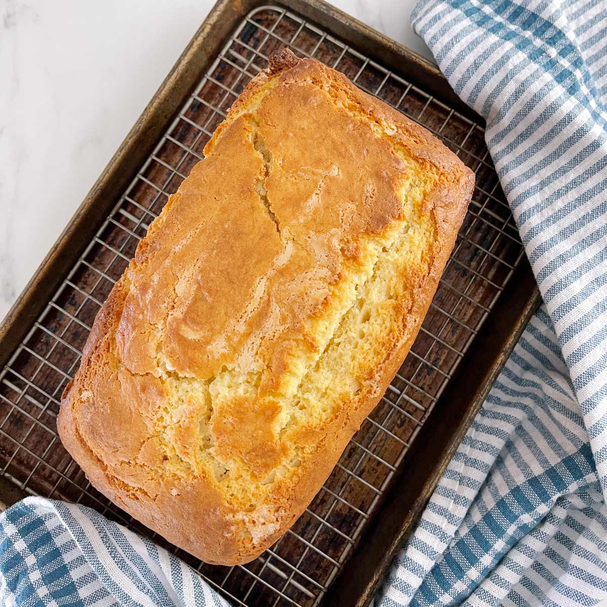 Completely baked lemon pound cake on cooling rack.
