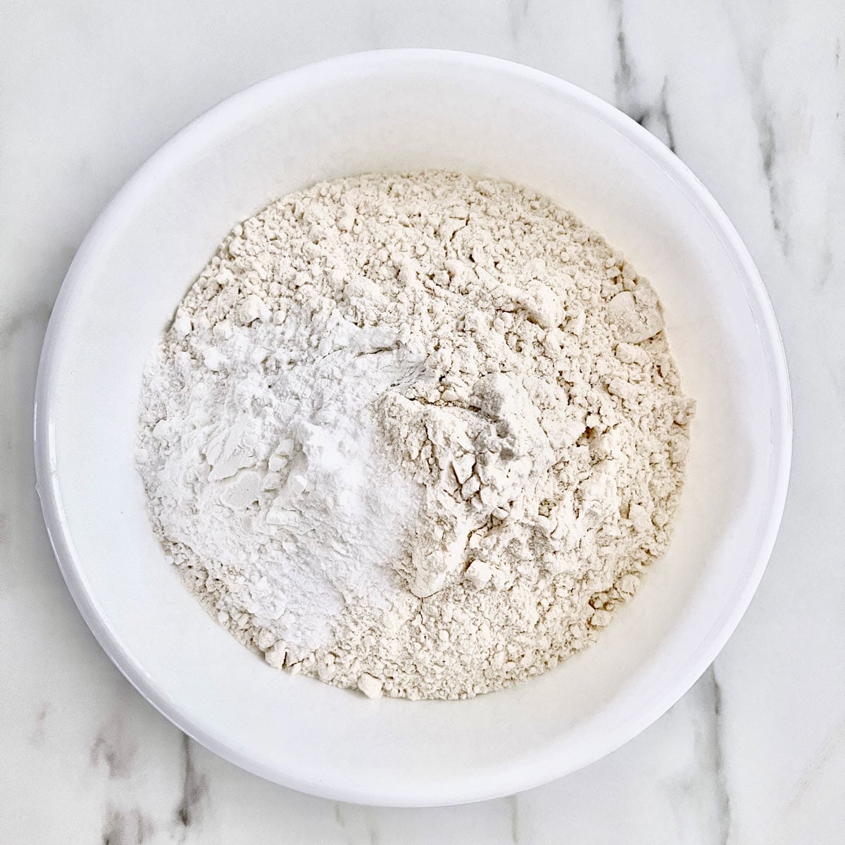 Flour, salt, baking powder and baking soda in a mixing bowl.