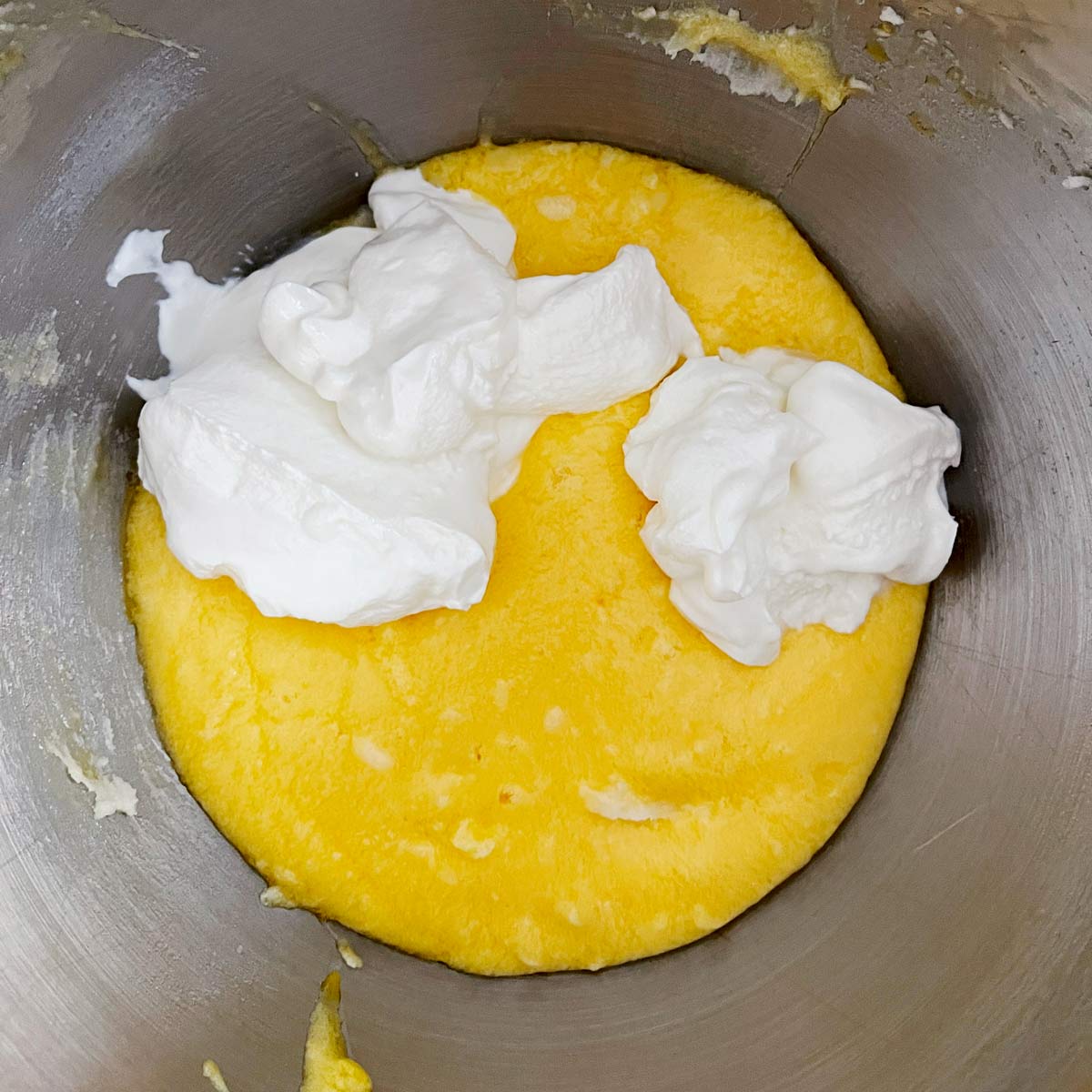 adding ingredients to the lemon poundcake batter.