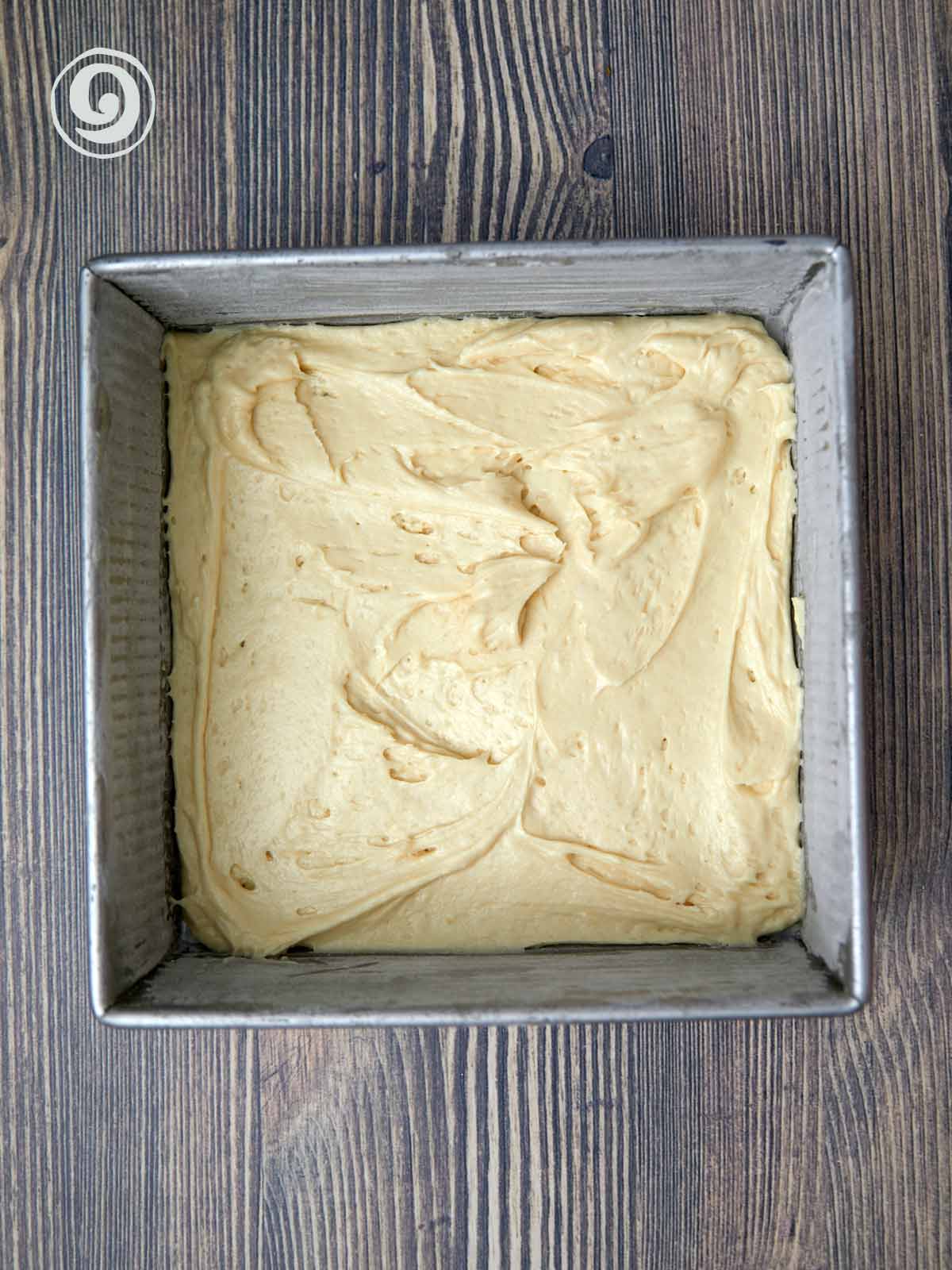 One half the cake batter in the bottom of the prepared pan.