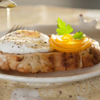 Lemon Poached Egg with sliced lemon garnish.