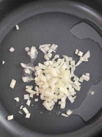 Skillet with oil and onions.