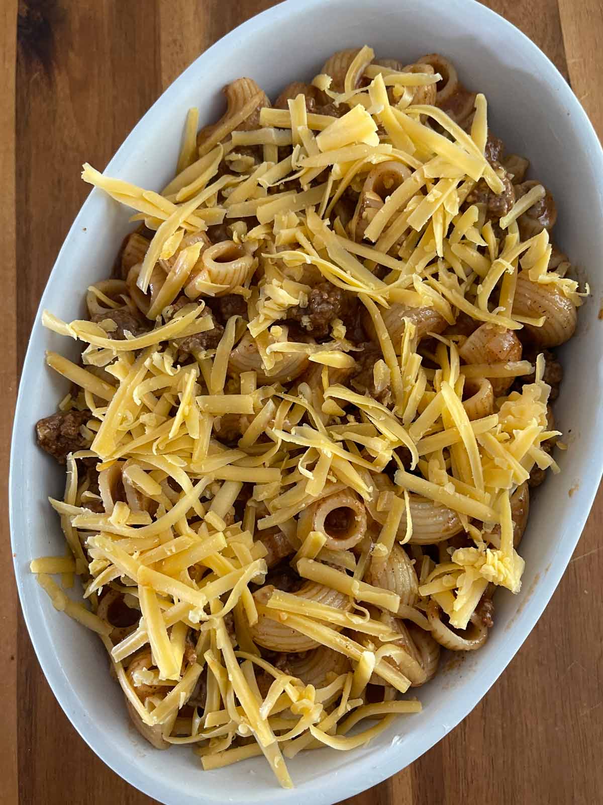 Mixture added toan oval casserole dish and topped with cheese.