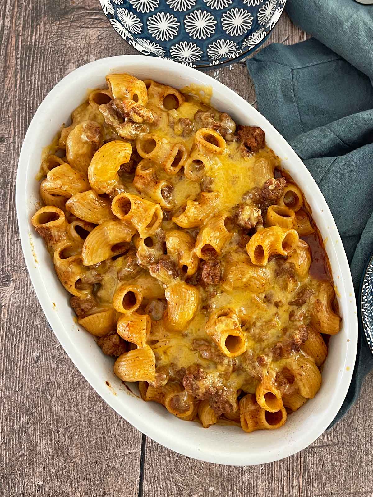 Fully baked chili mac with melted cheese on top.