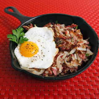 Cst iron skillet with hash and egg.