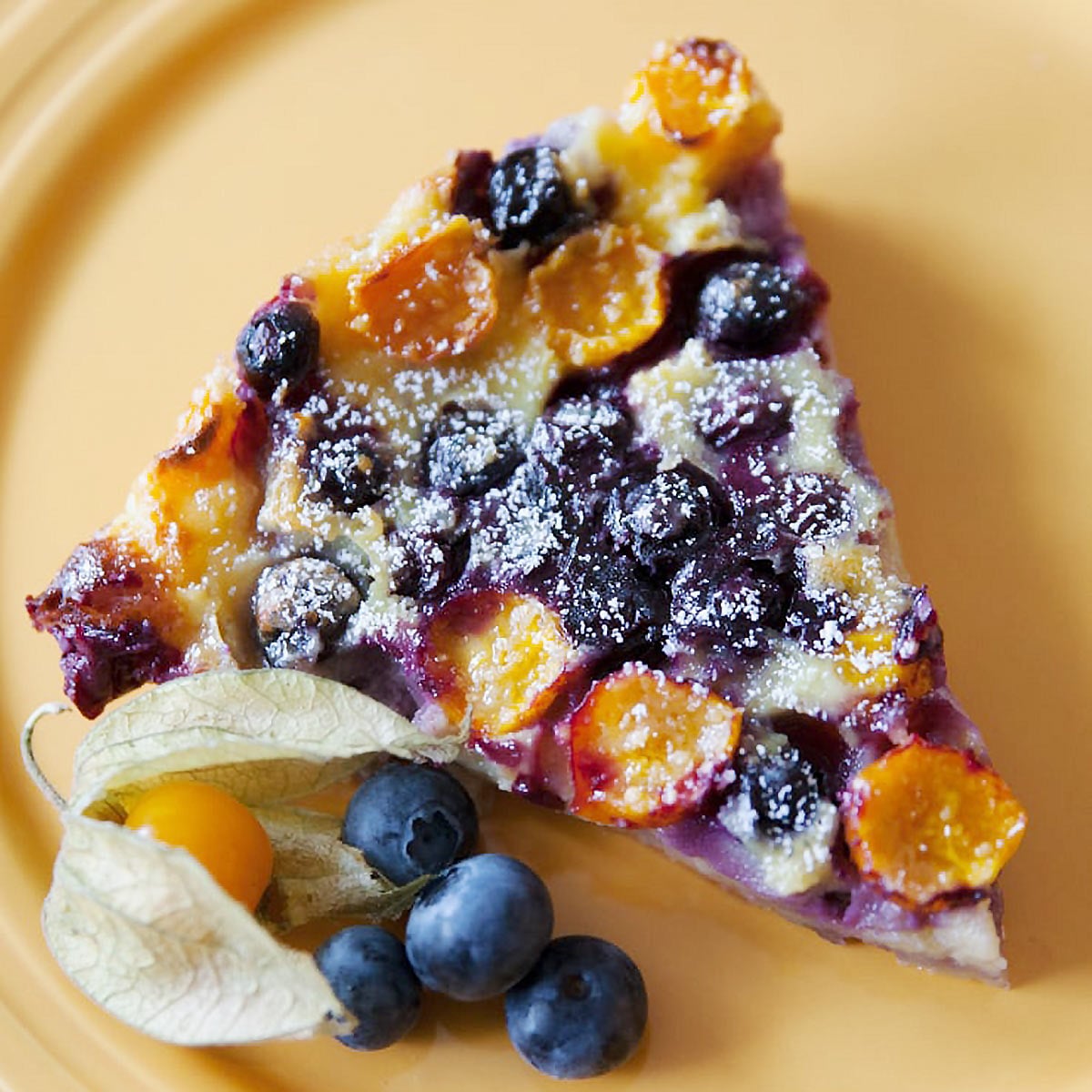 Image of a slice of Pichuberry and blueberry tart.