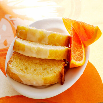 Sliced sunshine tangerine cake on a plate.