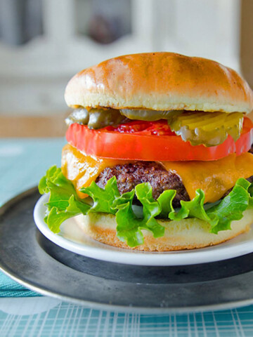 Cheeseburger with Kobe beef, lettuce, and tomatoes.