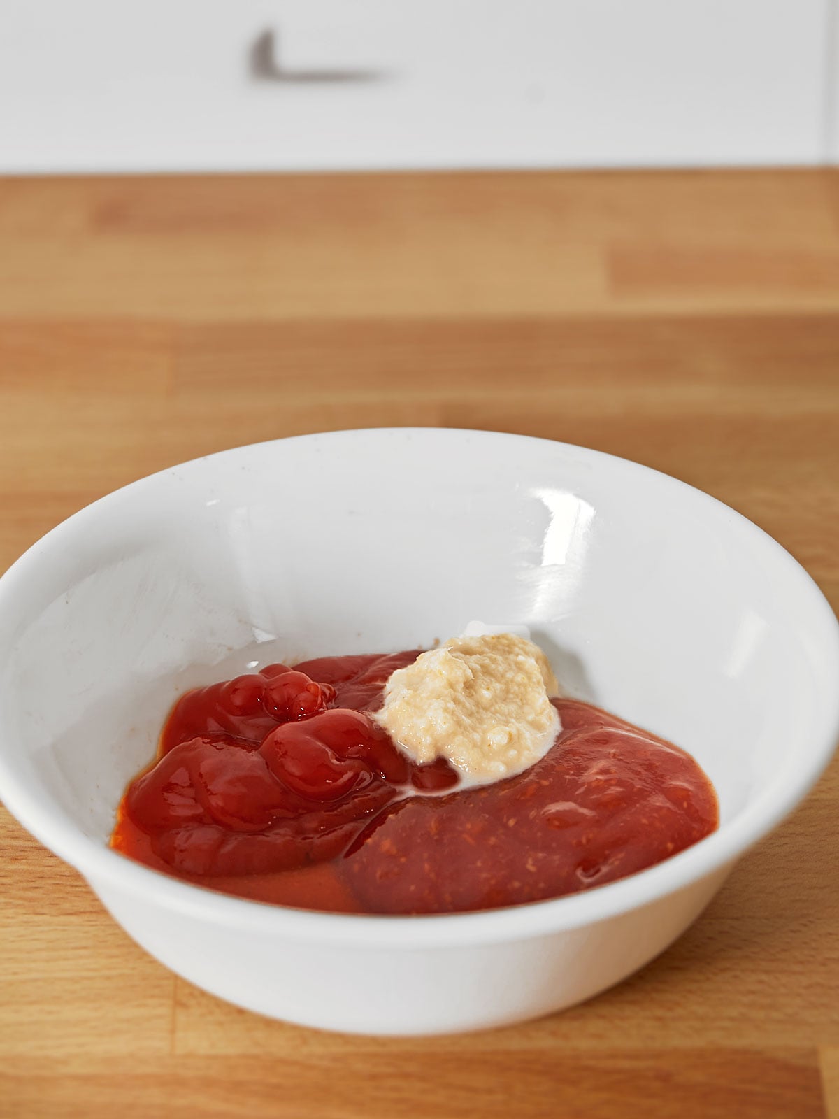 A bowl of ingredients on a wooden table.