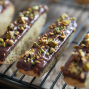 Almond biscotti with chocolate ganache and pistachios.