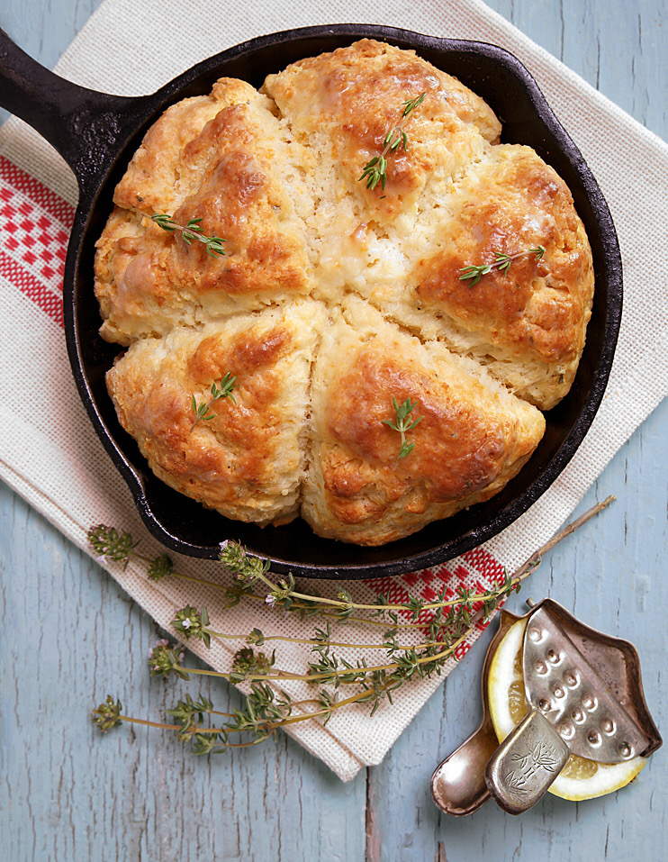 Cast iron skillet with scones and lemon squeezer.