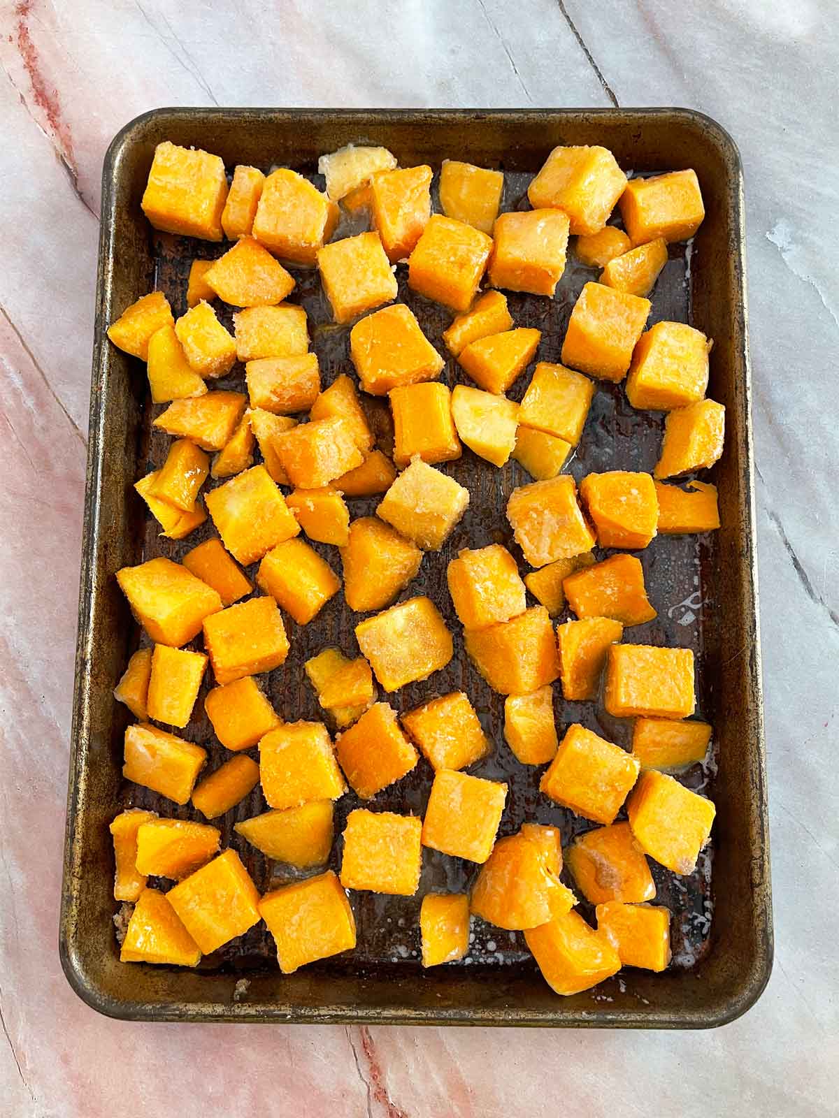 All the ingredients on the baking sheet mixed together.