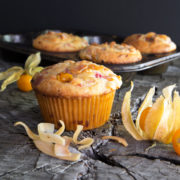 Pichuberry Muffins on a slab of weathered wood.