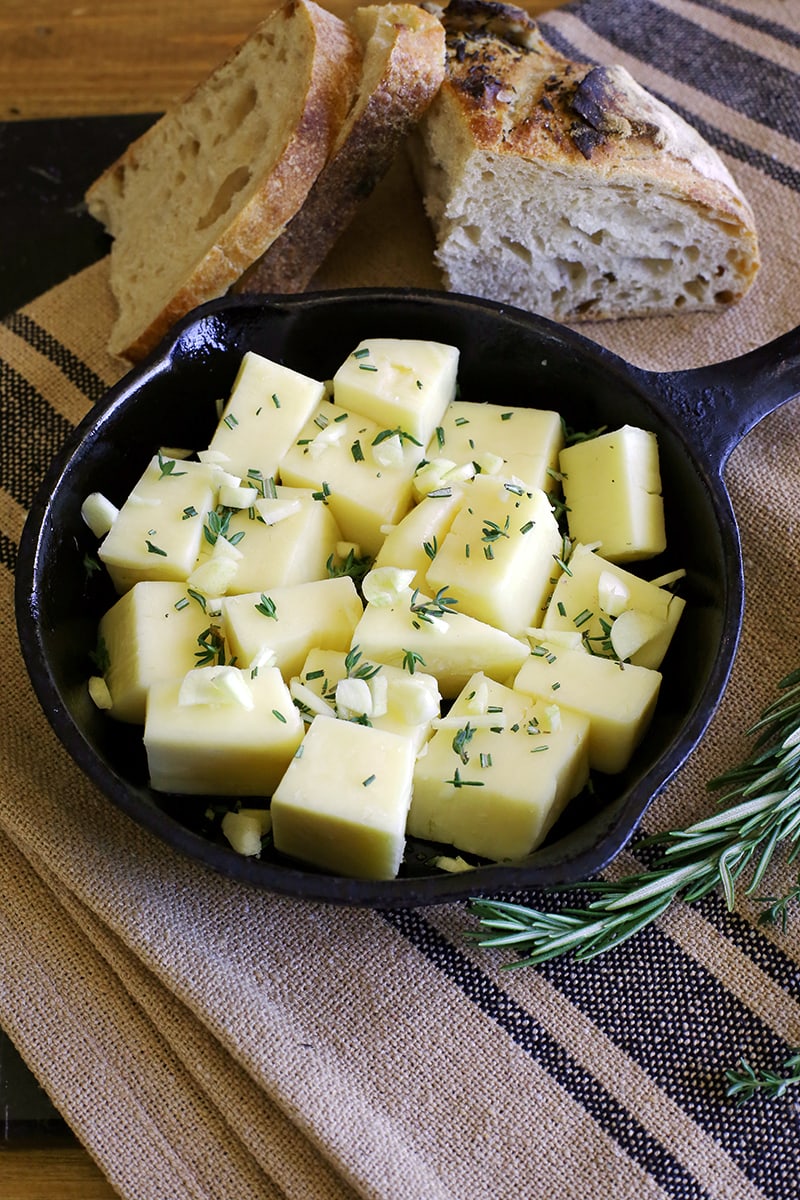 Fontina cheese cubed with garlic and herbs.