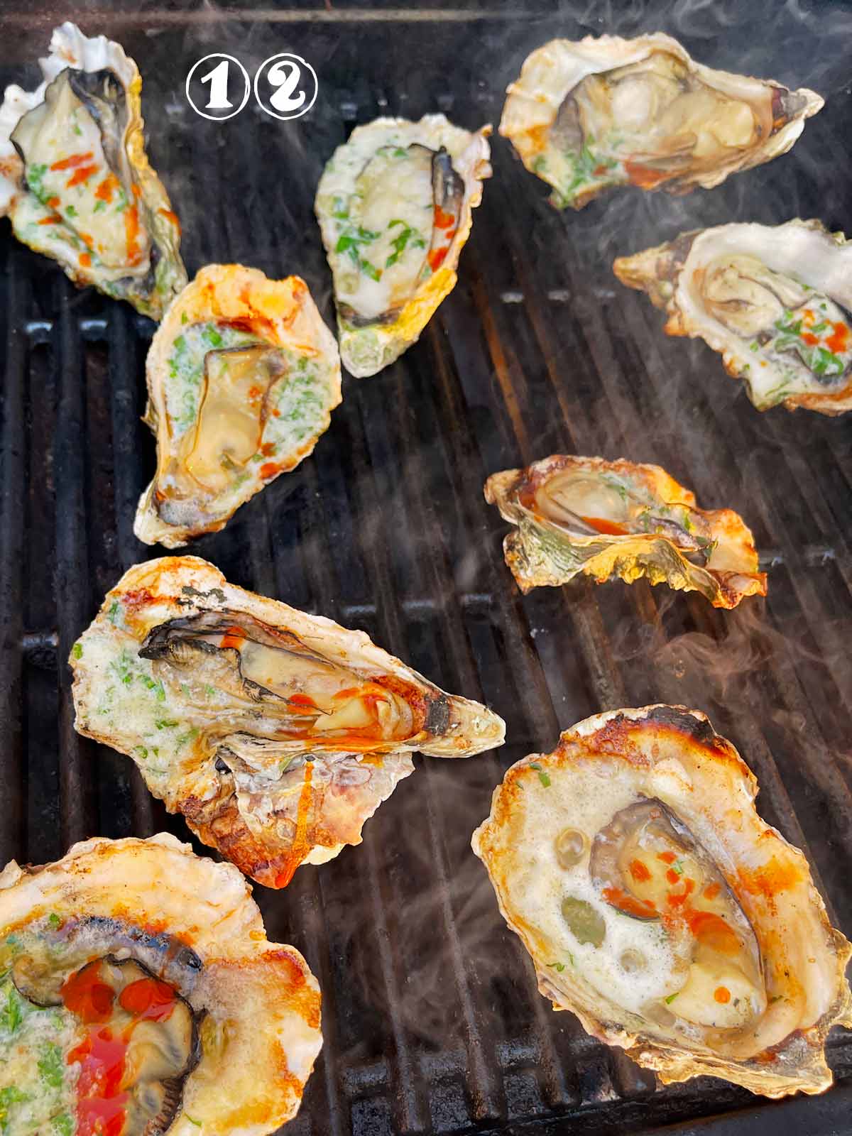 Grilled oysters with Parmesan. and hot sauce.