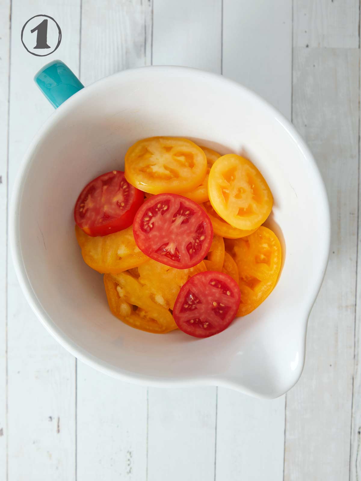 Bowl of sliced tomatoes.
