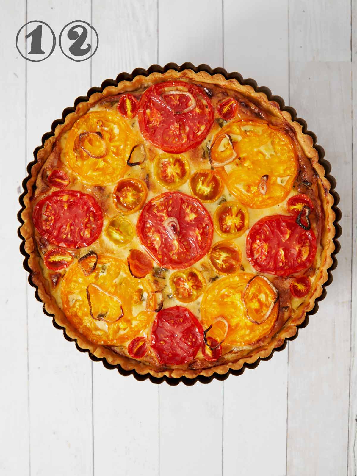 Fully baked Heirloom Tomato Tart with Basil and Gruyere Cheese.