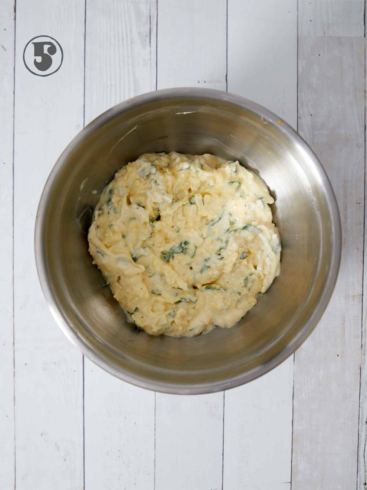Bowl full of cheese mixture.