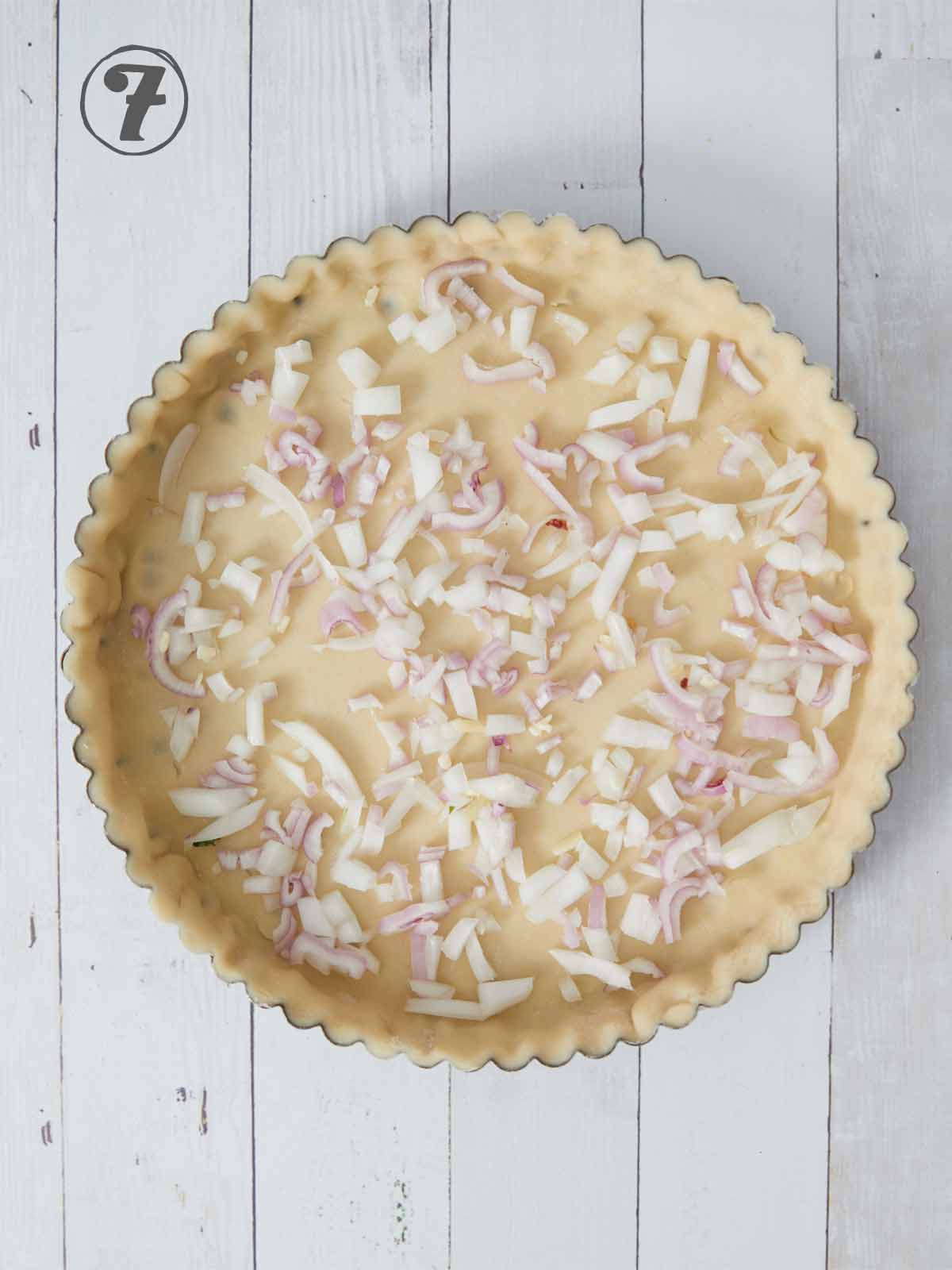 Pie crust with onions on the bottom.