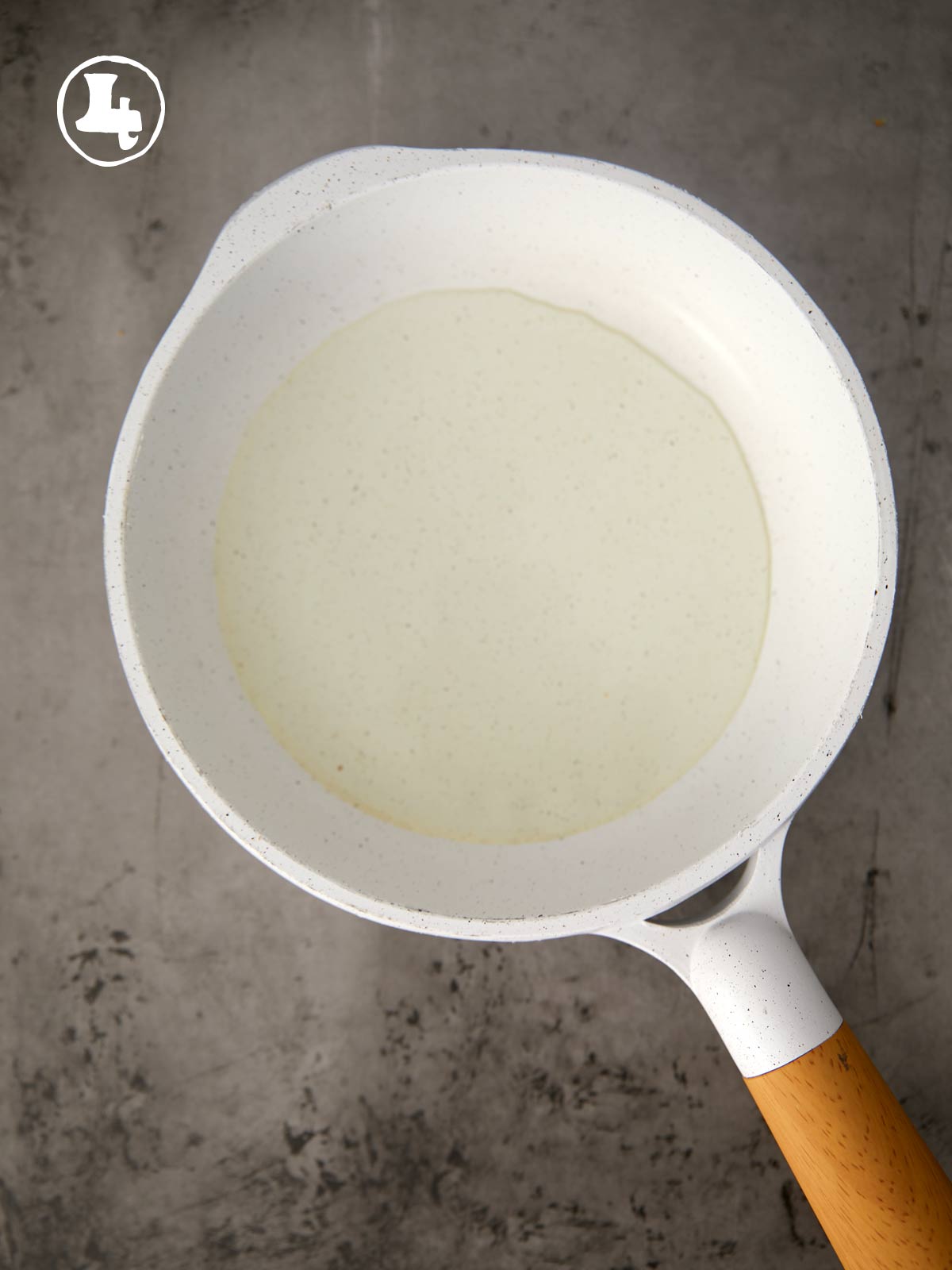 A white pan with oil.