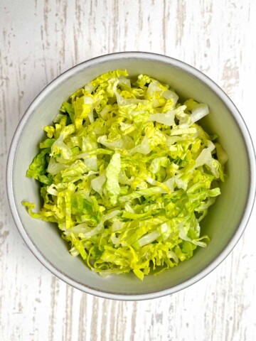 Bowl of finely shredded Romaine lettuce.