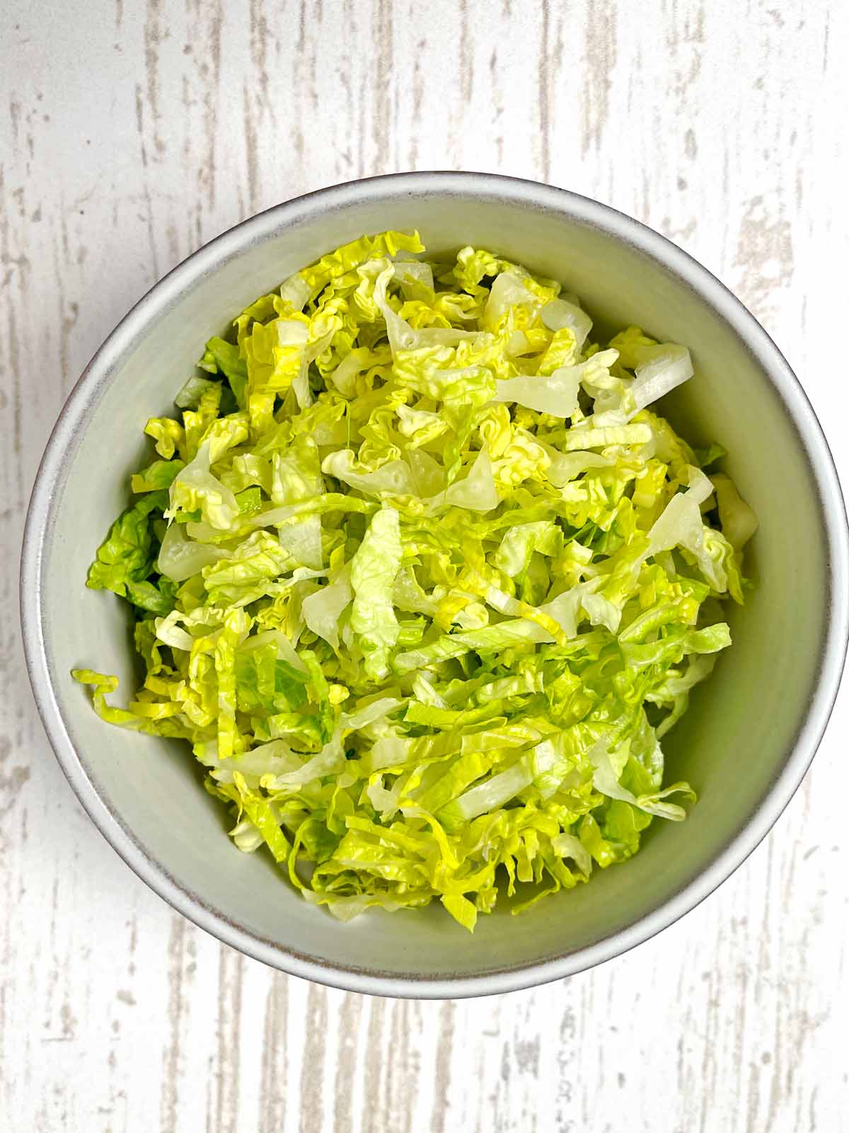 Bowl of finely shredded Romaine lettuce.