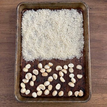 Baking sheet with bread crumbs and macadamia nuts ready to roast.
