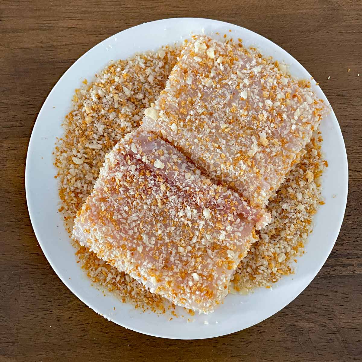 Halibut filets dredged in breading mixture.