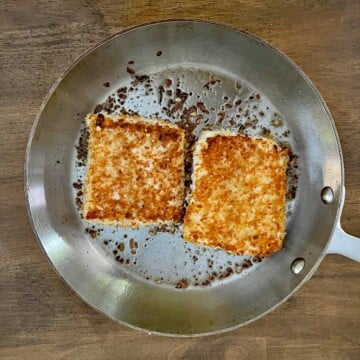 Halibut fillets cooking in saute pan.