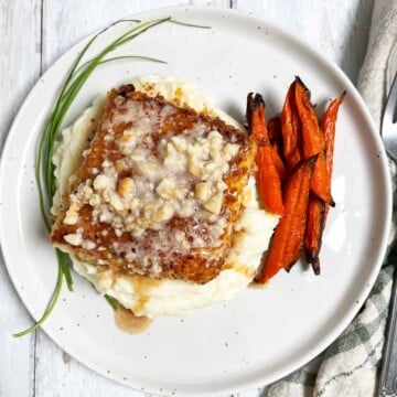 Plate of food ready to serve with macadamia nut brown butter poured on top.