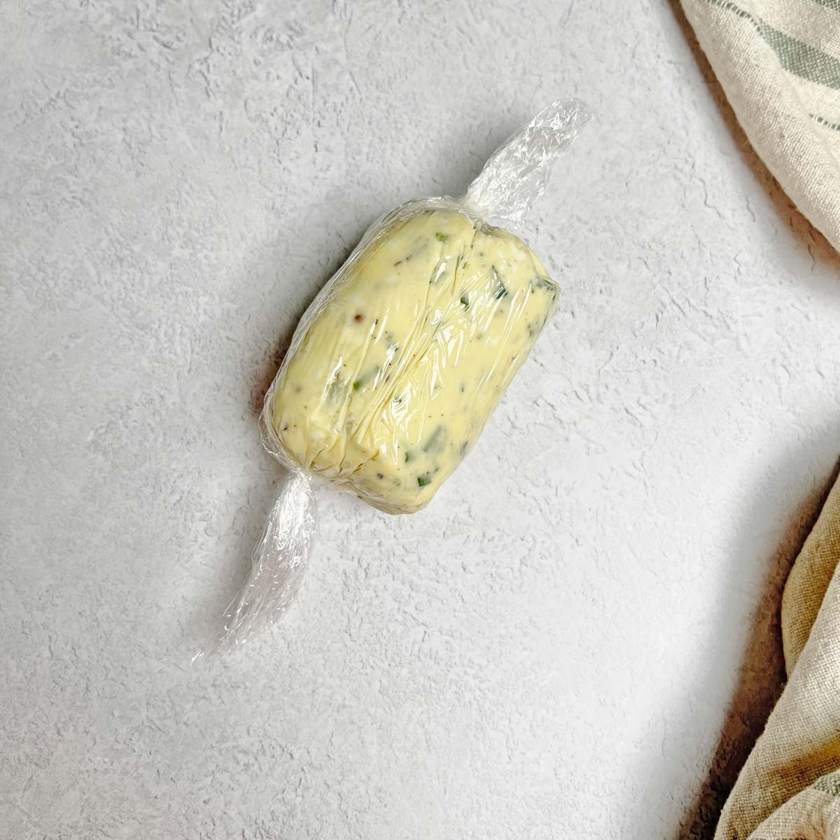 Gorgonzola butter shaped into a log and rolled in plastic wrap.
