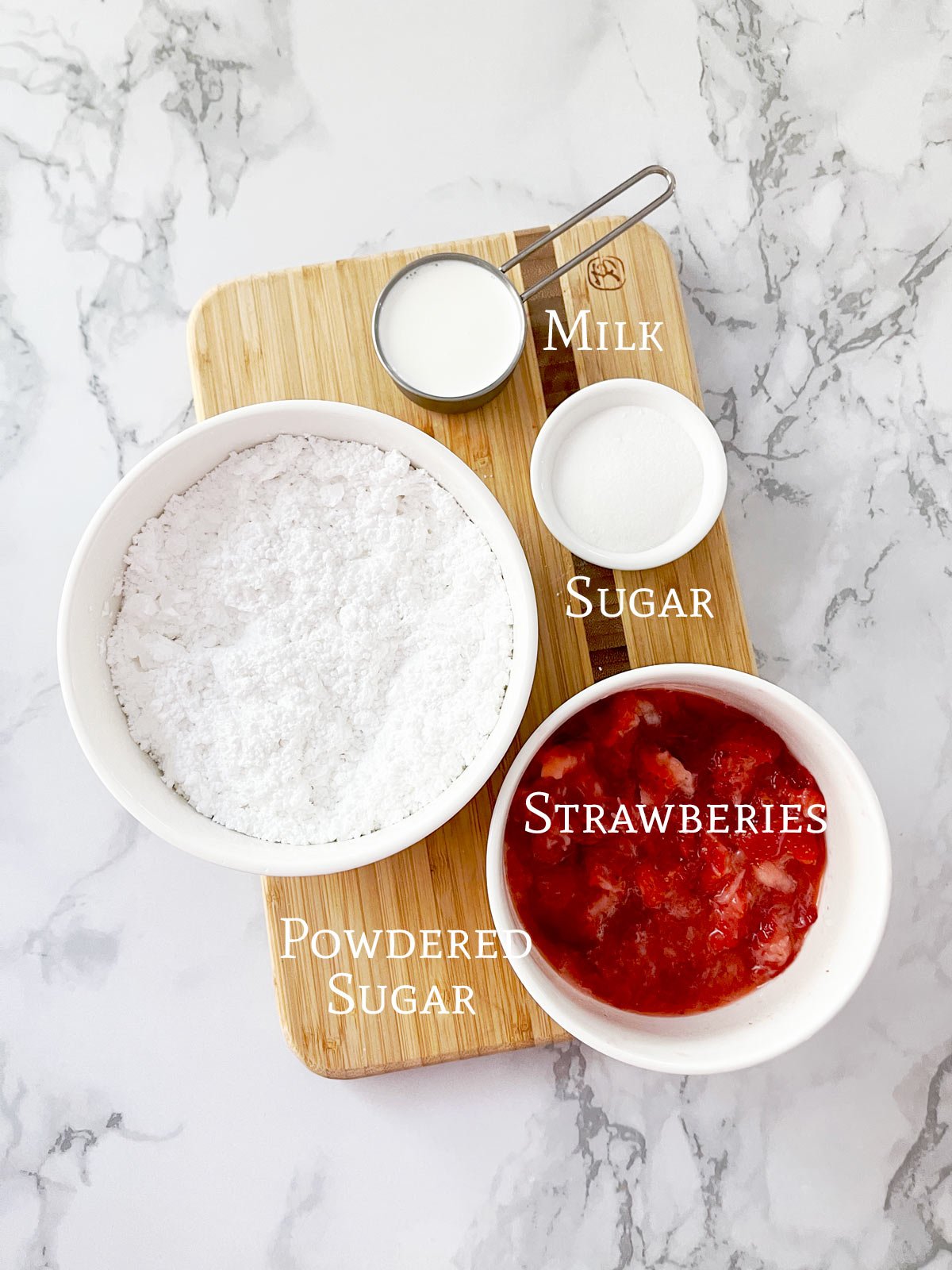 Ingredients for strawberry glaze on cutting board.