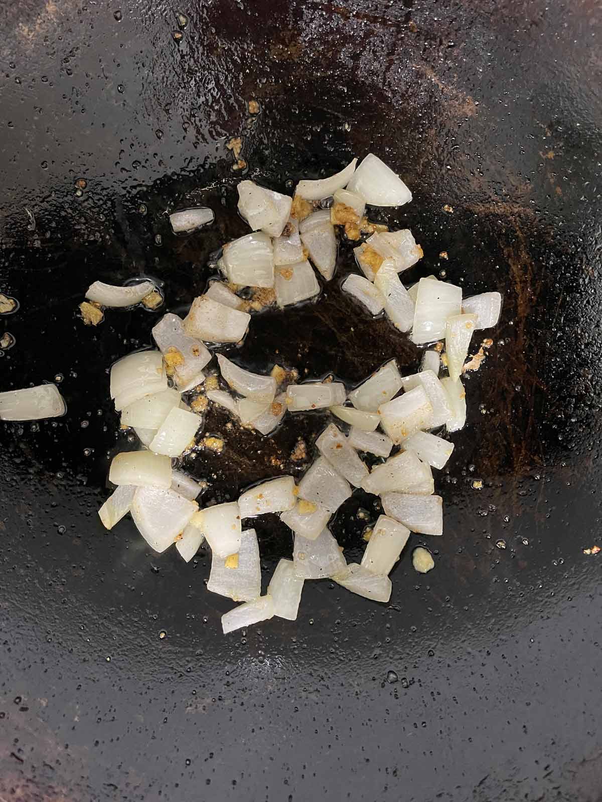 Cooked onions in a wok.