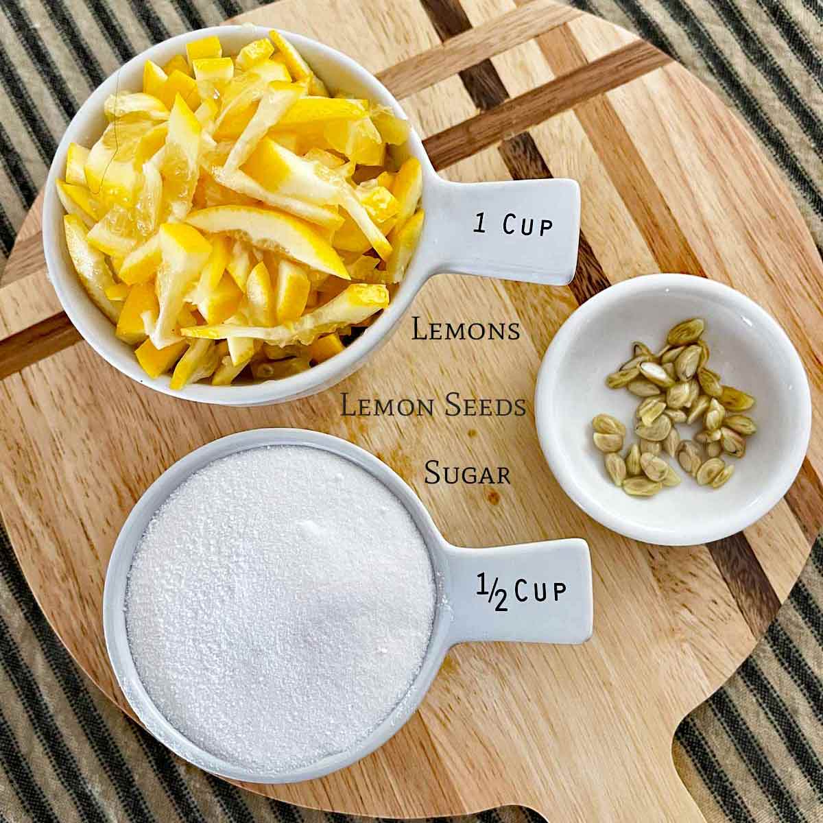 All of the ingredients for lemon marmalade. Sliced and slivered lemons, seeds, and sugar.