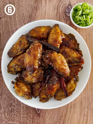 Grandmother's Chinese Chicken Wings, served with sauce and green onions.