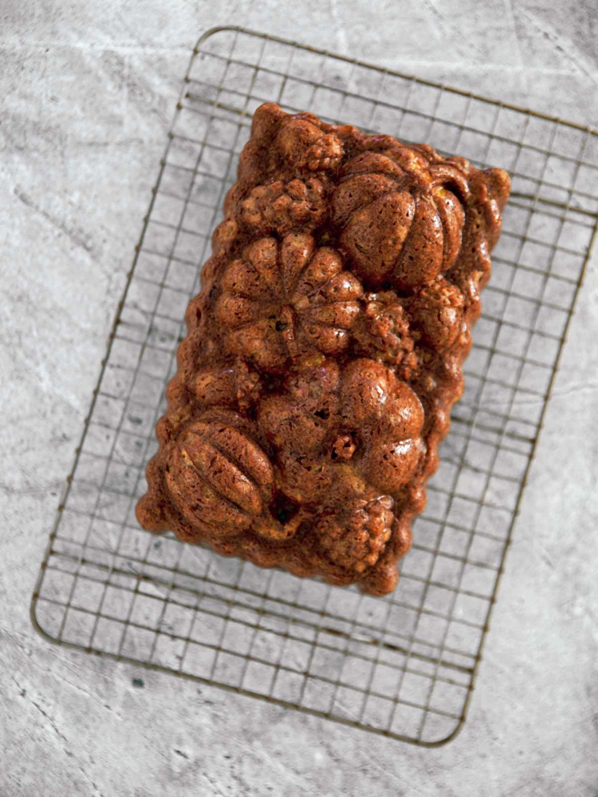 Fully baked persimmon bread cooling on a wire rack.
