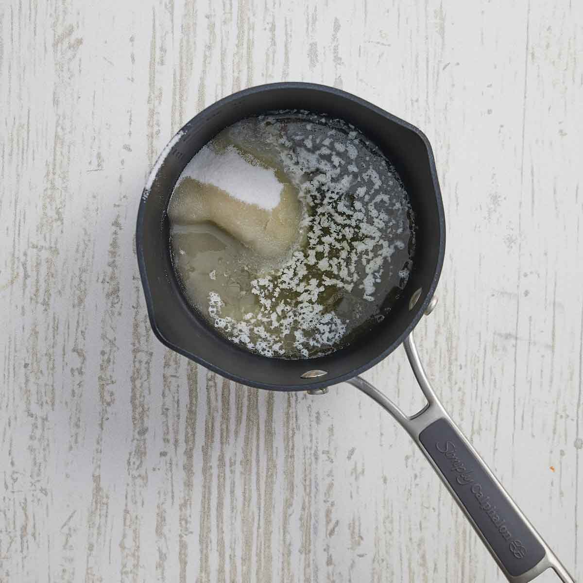 Small pan with melted butter and granualted sugar.